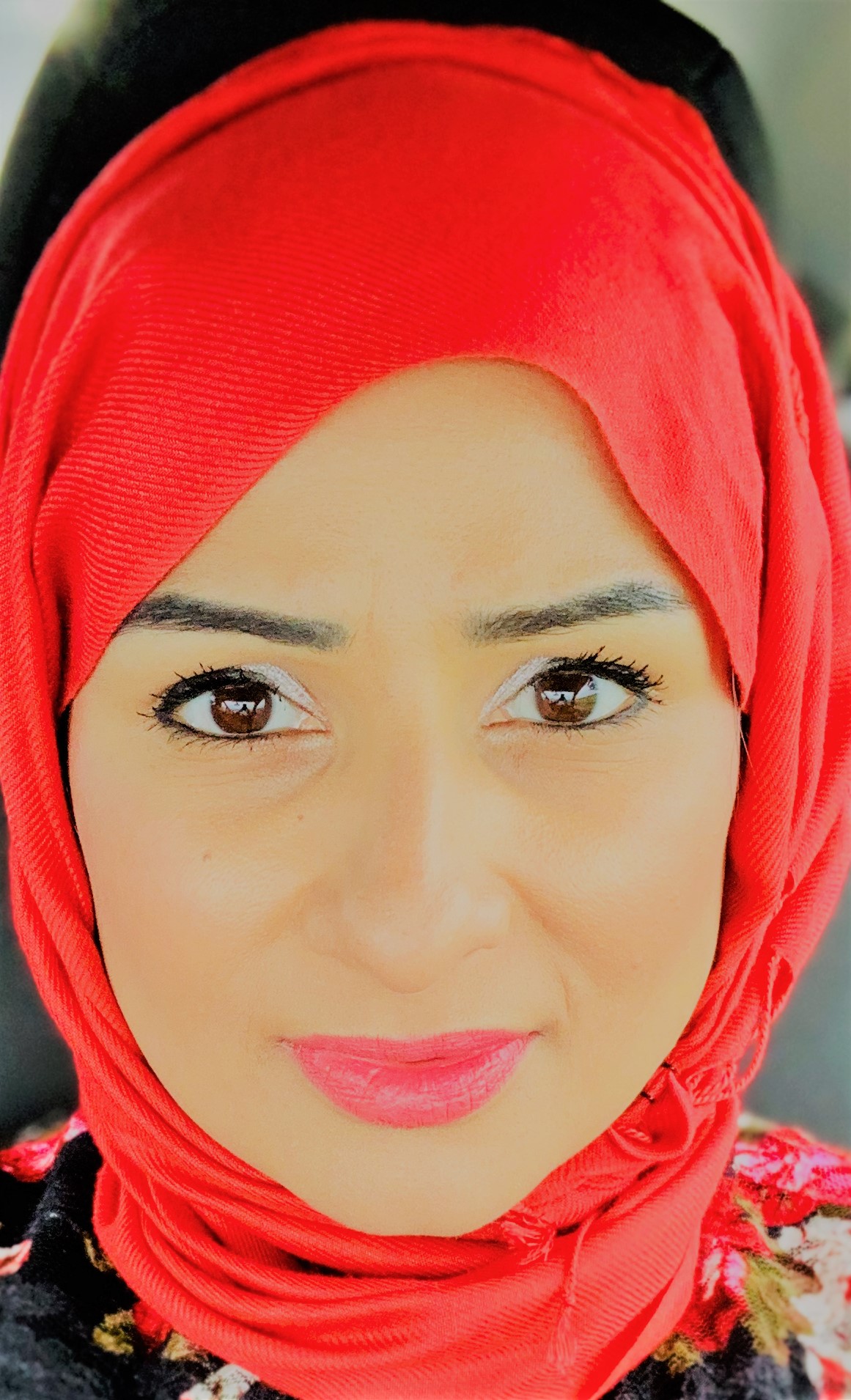 A woman wearing a red headscarf.