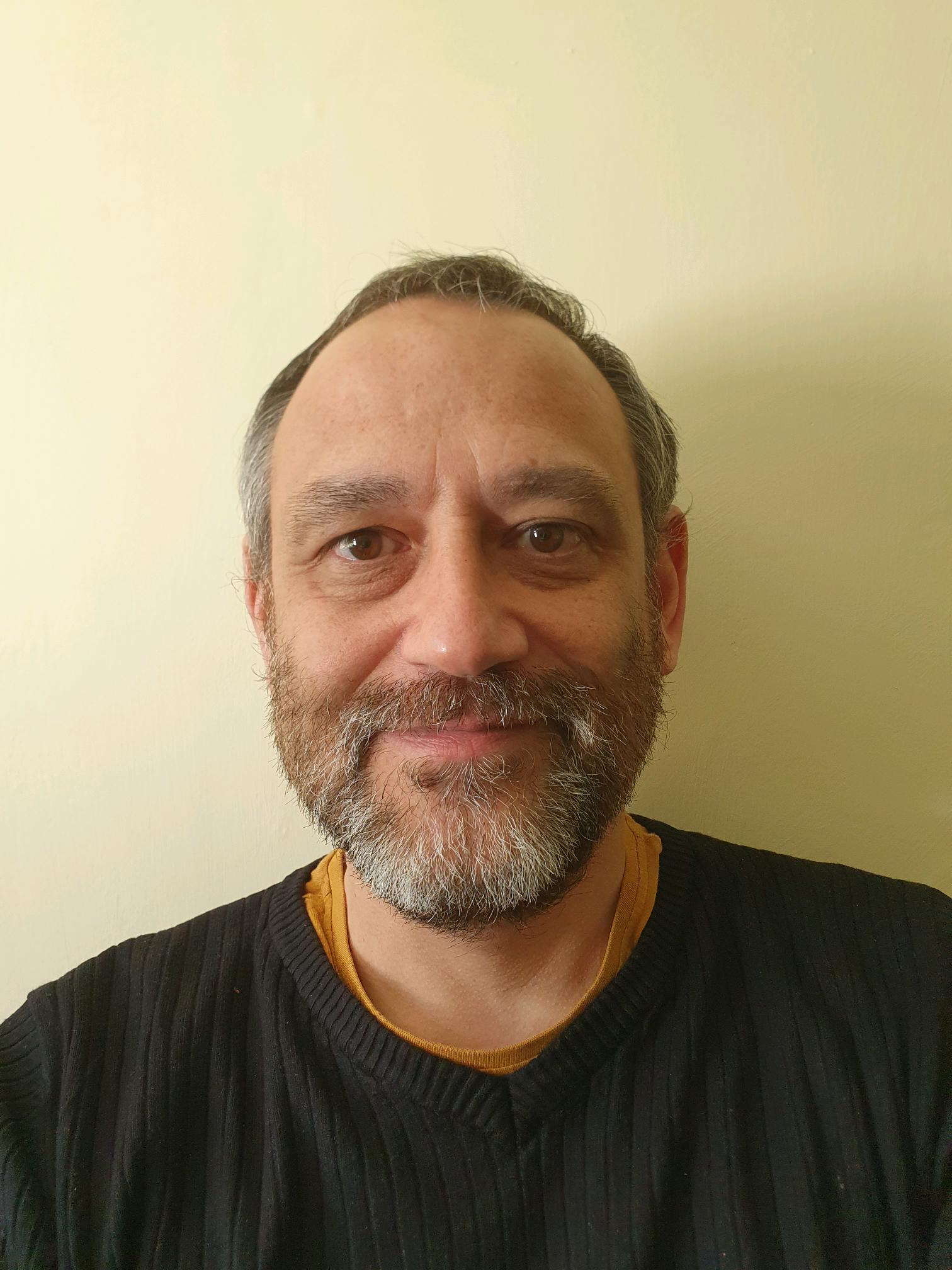 A man with a beard, wearing a black jumper.
