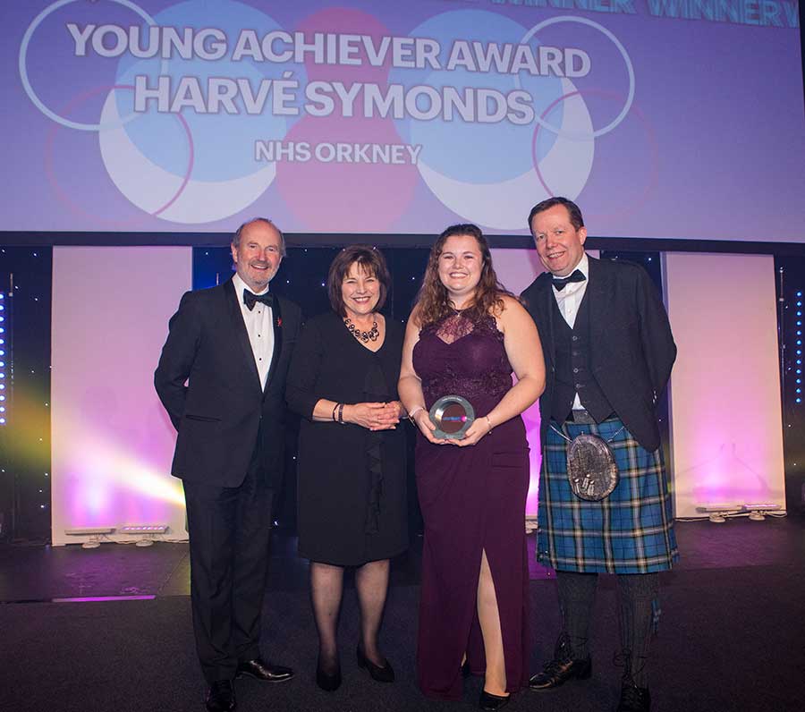 A group of people holding a prize at the Scottish Health Awards