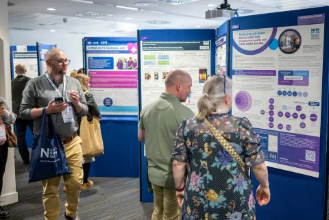People looking at a poster display