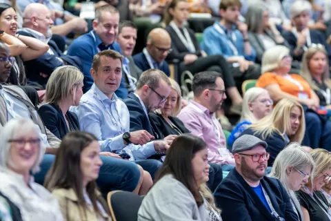 Audience members in bank seating