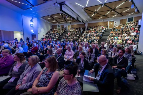 Audience members in bank seating