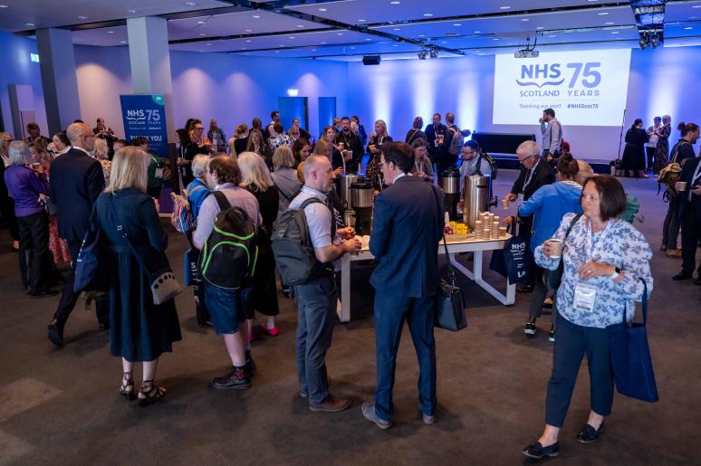 A large group of event attendees chatting