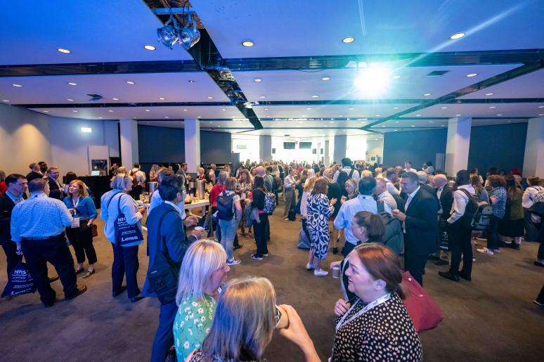 Multiple large groups of event attendees chatting