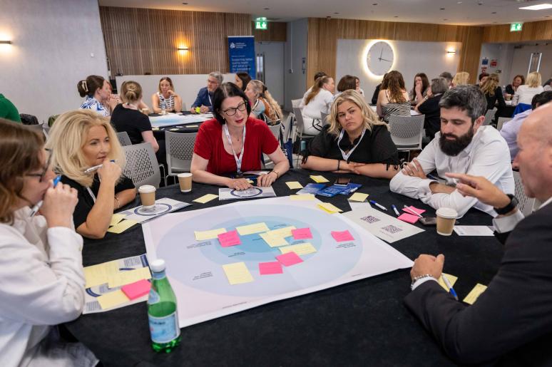 A group of event attendees sitting at a table during a workshop