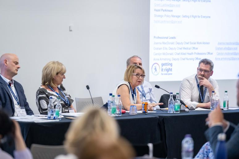A panel of speakers during a session