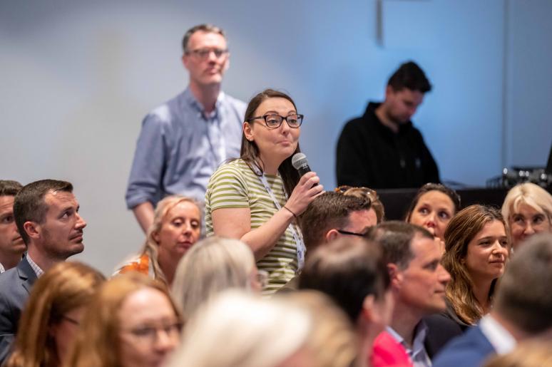 Several event attendees watching a presentation