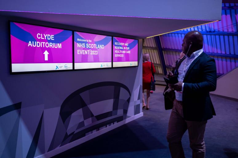 TV screens showing the name of the upcoming event