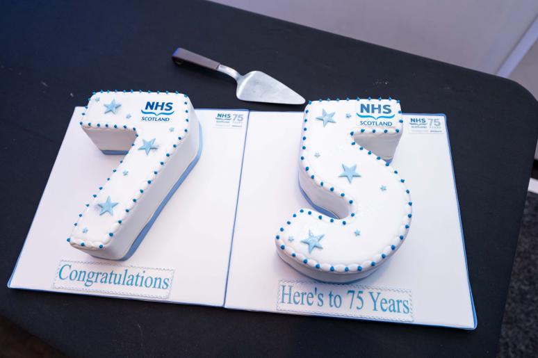 A cake in two parts, one part is in the shape of the number seven, the other part is in the shape of the number five