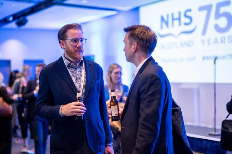 A speaker chatting to an event attendee