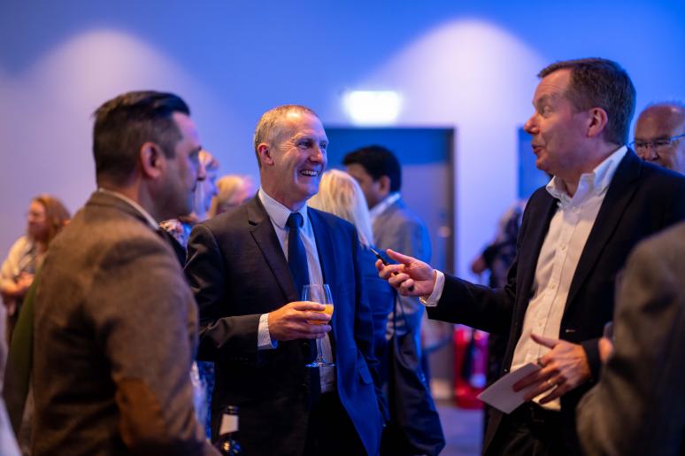 Three event attendees speaking