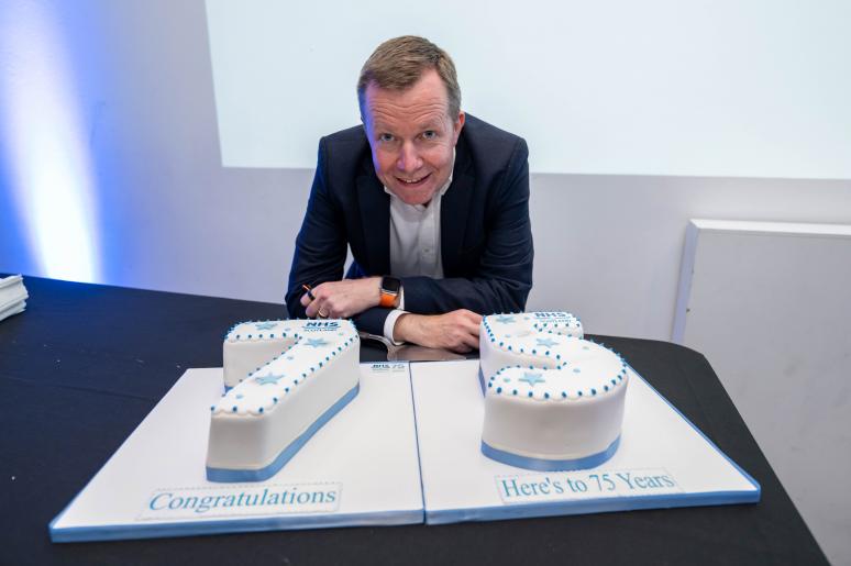 A man posing with the cake