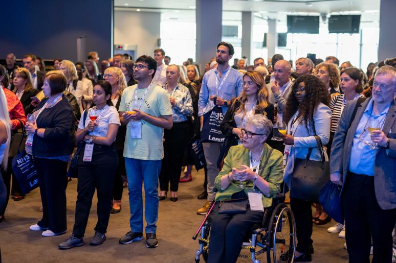 A large group of event attendees watching a presentation